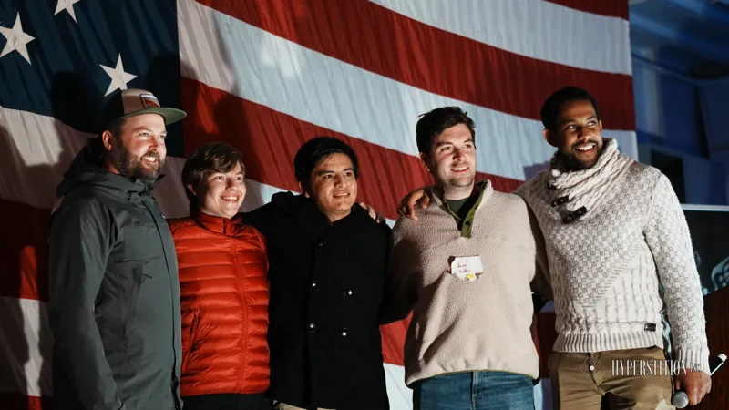 A group gathers for a photo in front of the main stage.